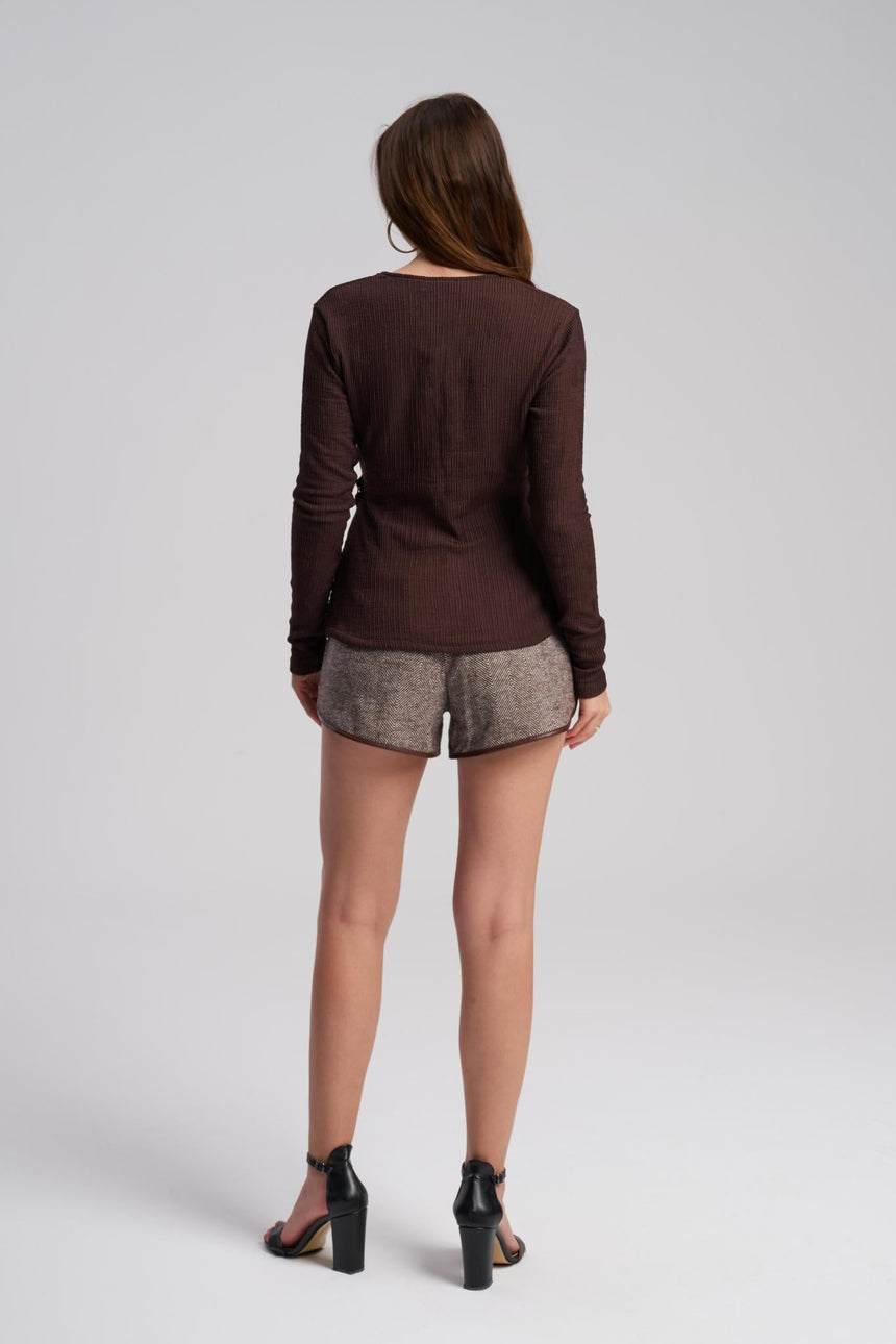 Stretch fitted evening top with gold accessory