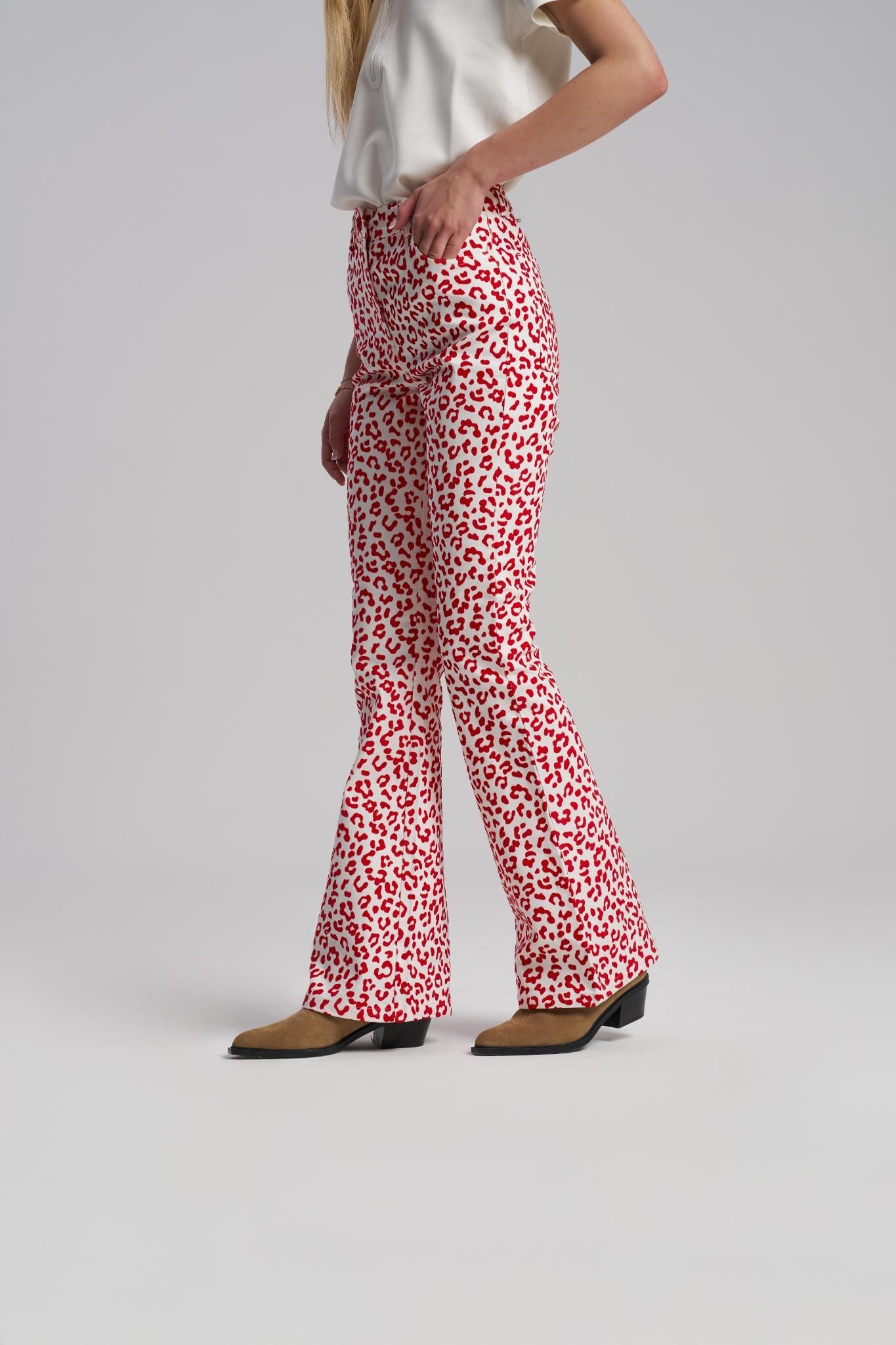 Person wearing red and white patterned pants on a plain background