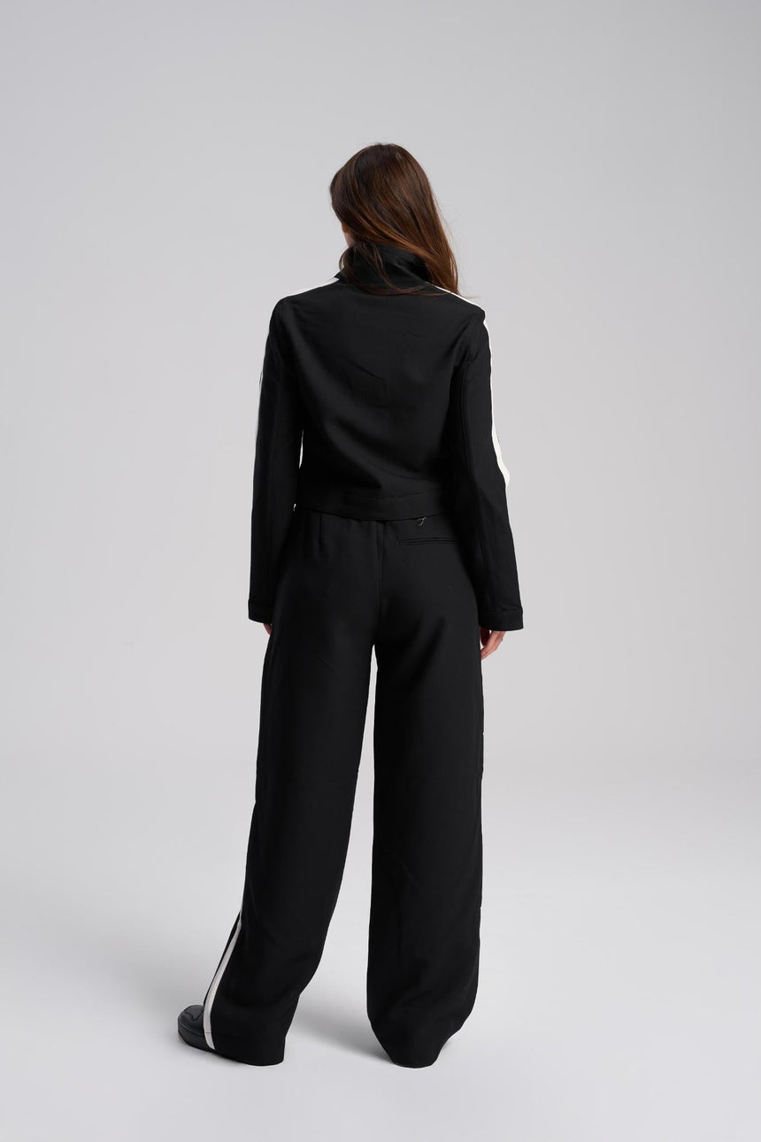 Person wearing a black suit on a white background