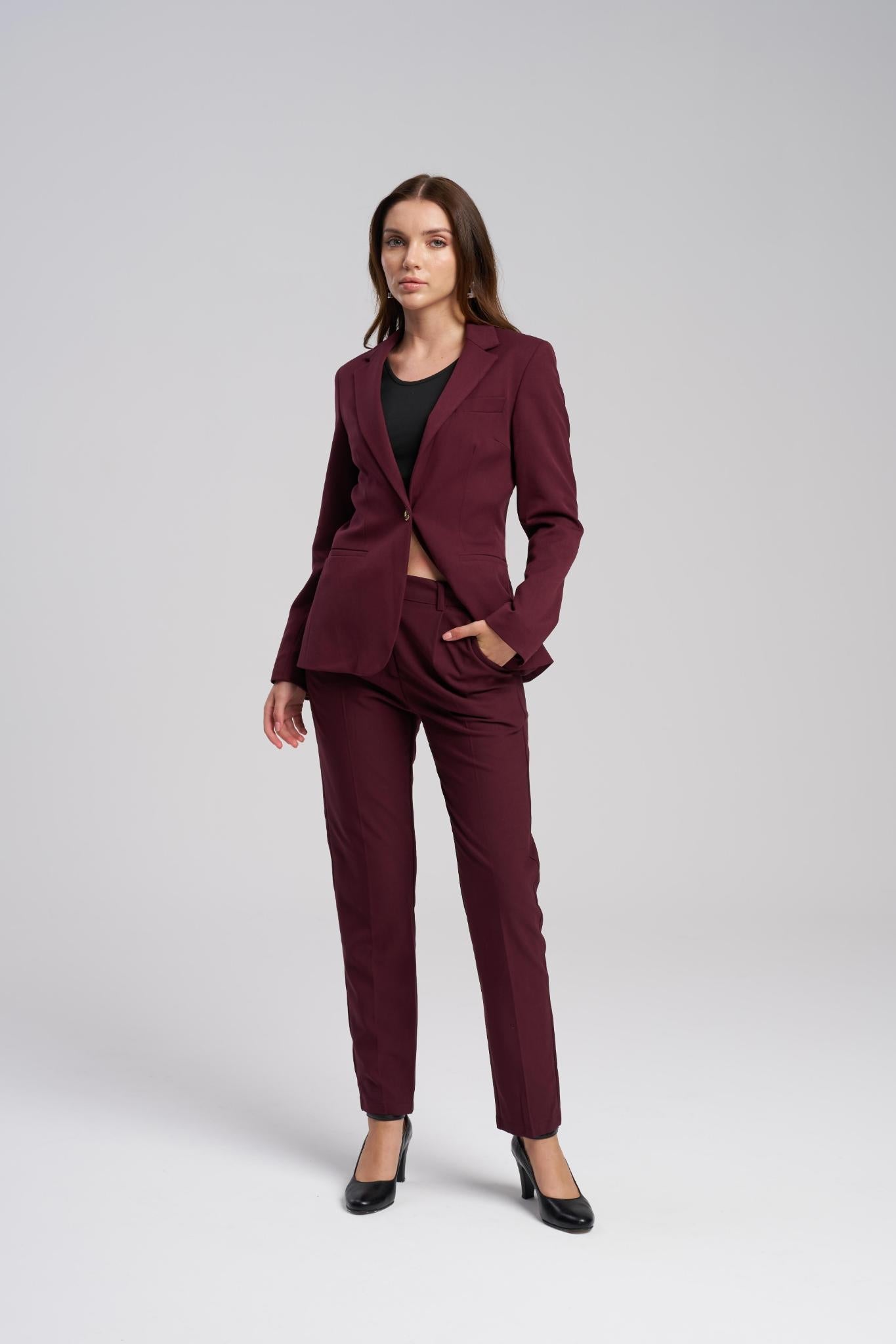 Woman wearing a burgundy suit on a white background
