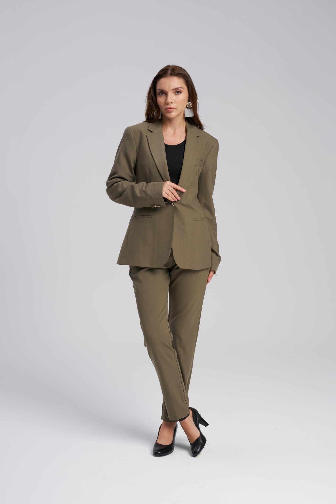 Woman wearing a green suit on a white background