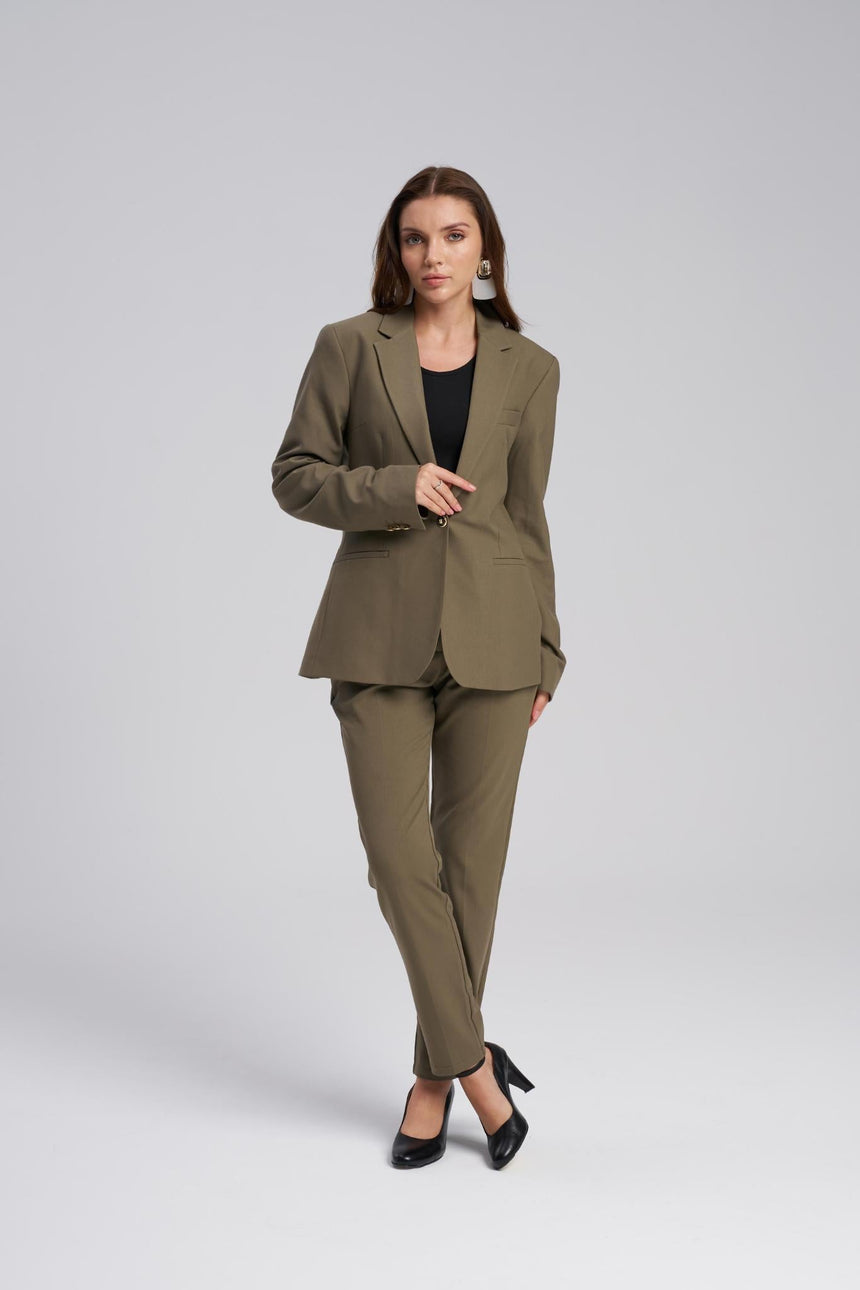 Woman wearing a green suit on a white background