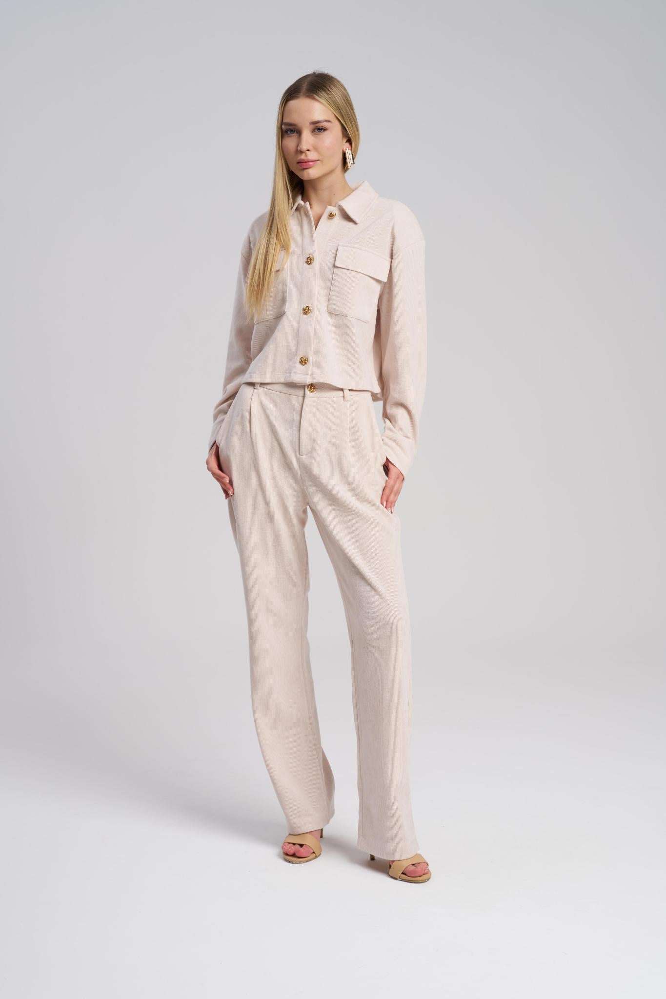 Woman wearing a beige outfit on a white background