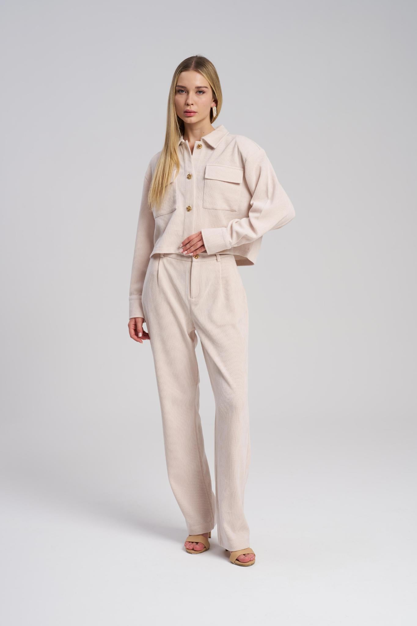 Woman wearing a beige outfit on a white background