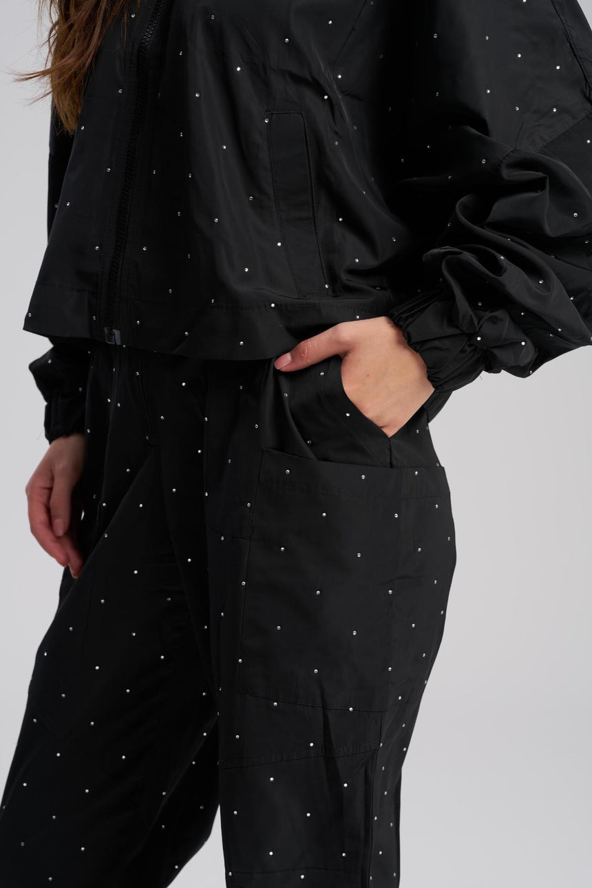 Black outfit with white polka dots on a plain background