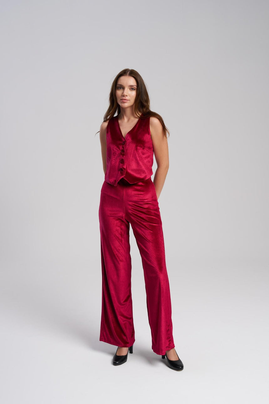 Woman wearing a red velvet outfit on a white background