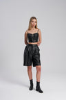 Woman wearing a black leather outfit on a white background