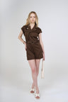 A chic utility-inspired cotton playsuit designed with a structured silhouette and comfortable stretch. Featuring a collared button-front top, short sleeves and shorts-style bottom, finished with a D-ring belt to define the waist. An effortless choice for everyday and summer styling.