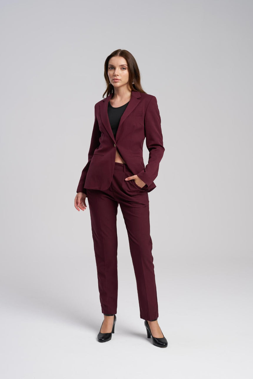 Woman wearing a burgundy suit on a white background