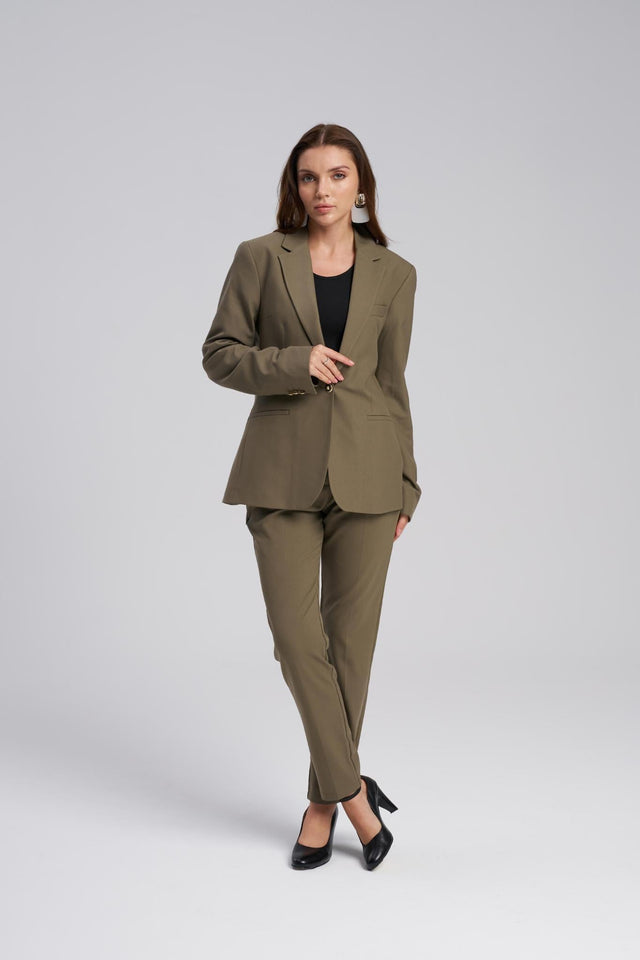 Woman wearing a green suit on a white background