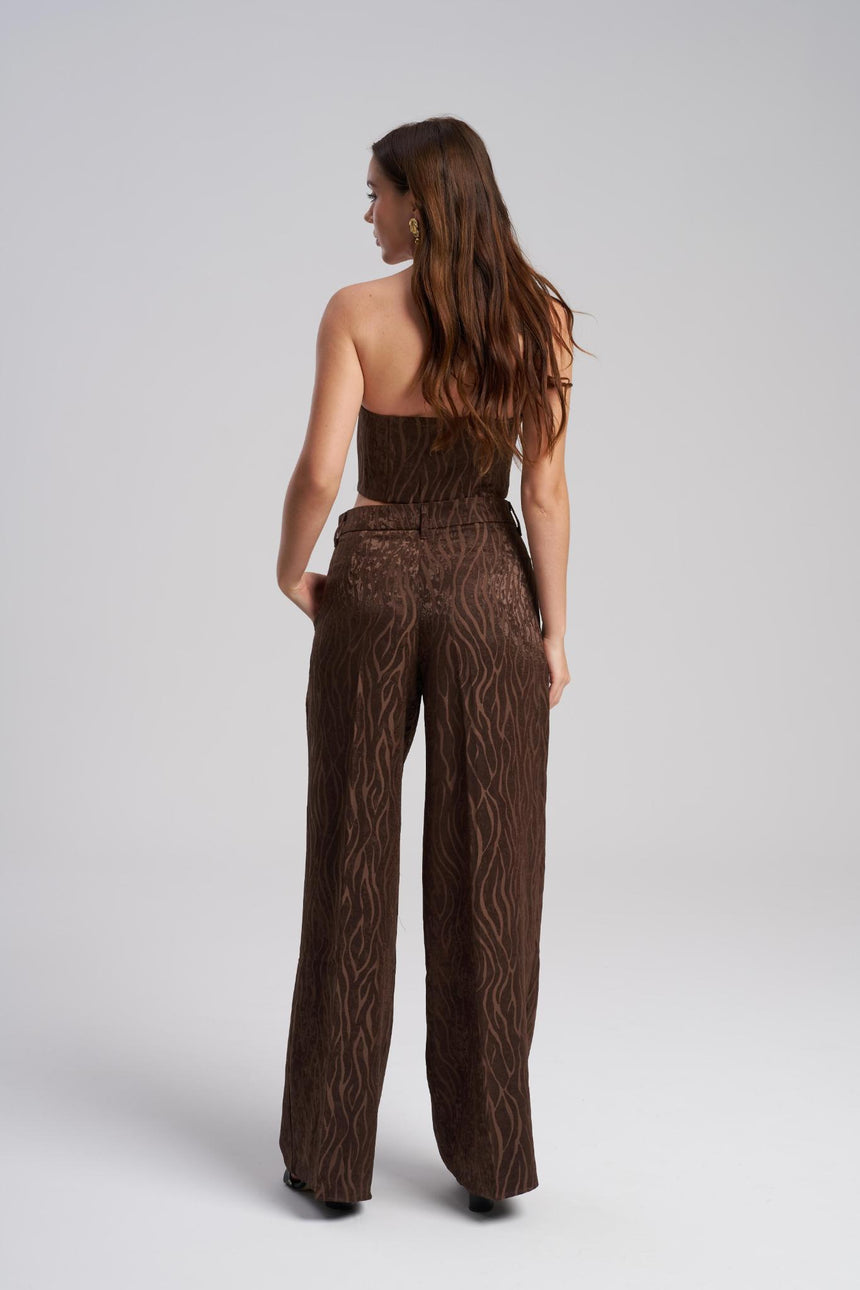 Woman wearing a brown textured outfit on a white background