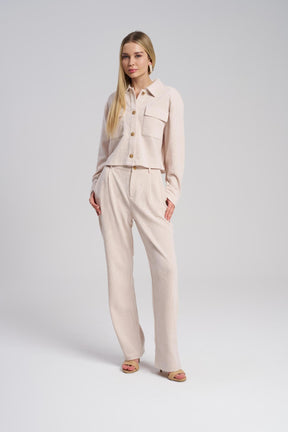 Woman wearing a beige outfit on a white background