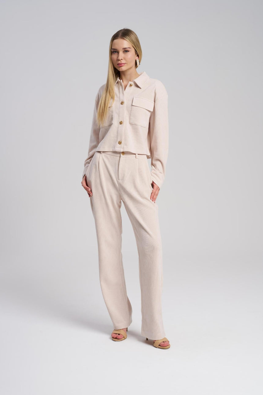Woman wearing a beige outfit on a white background