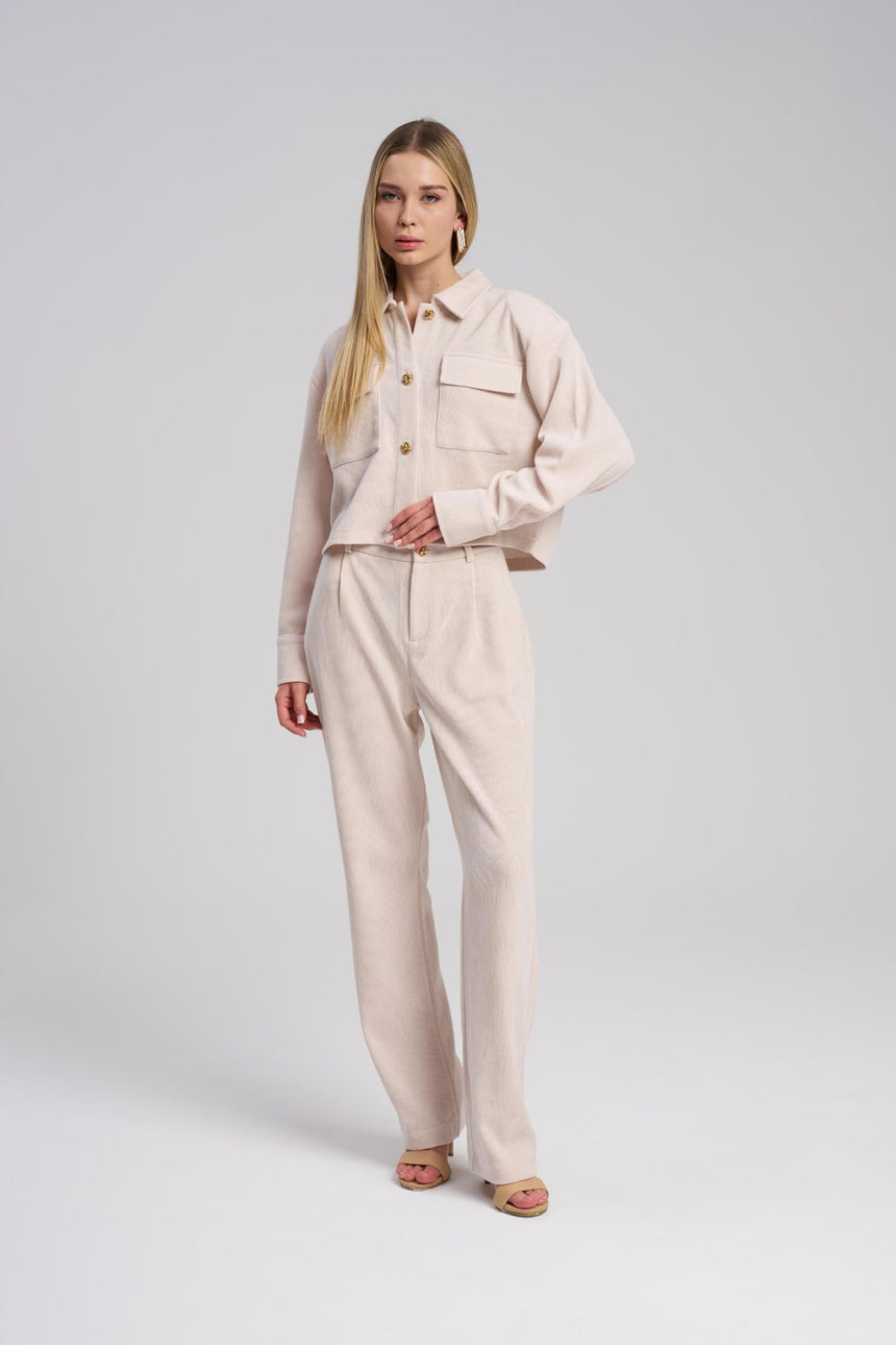Woman wearing a beige outfit on a white background